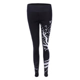 Sports women`s leggings  with a tree print
